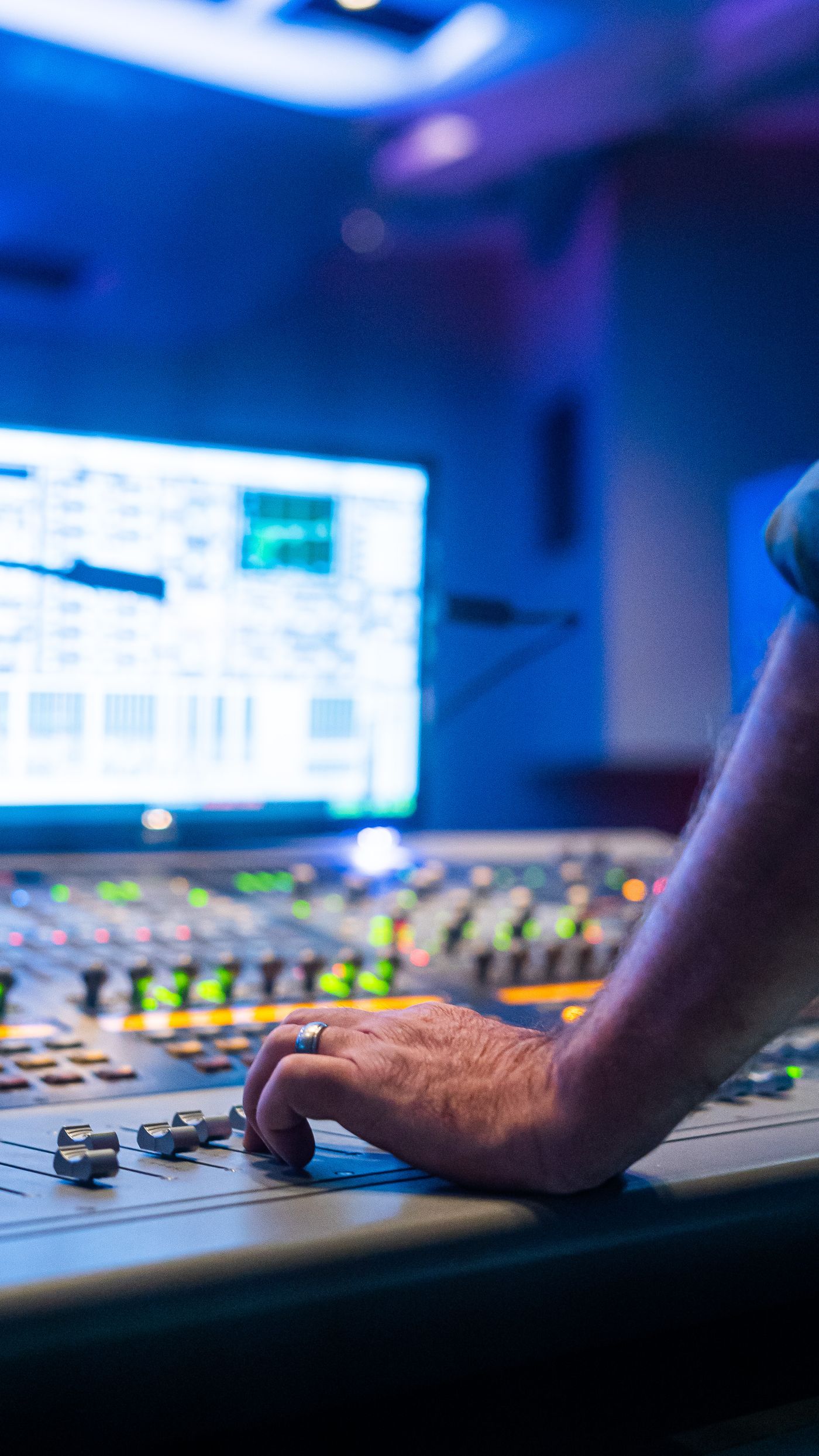 Professional mixing console in a dim studio